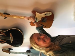 Melissa showing me her all-time favorite guitar, a Fender Strat. "If there's a fire and I can only grab one guitar, it's this one."