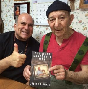 My father receiving his first published book on his 90th birthday
